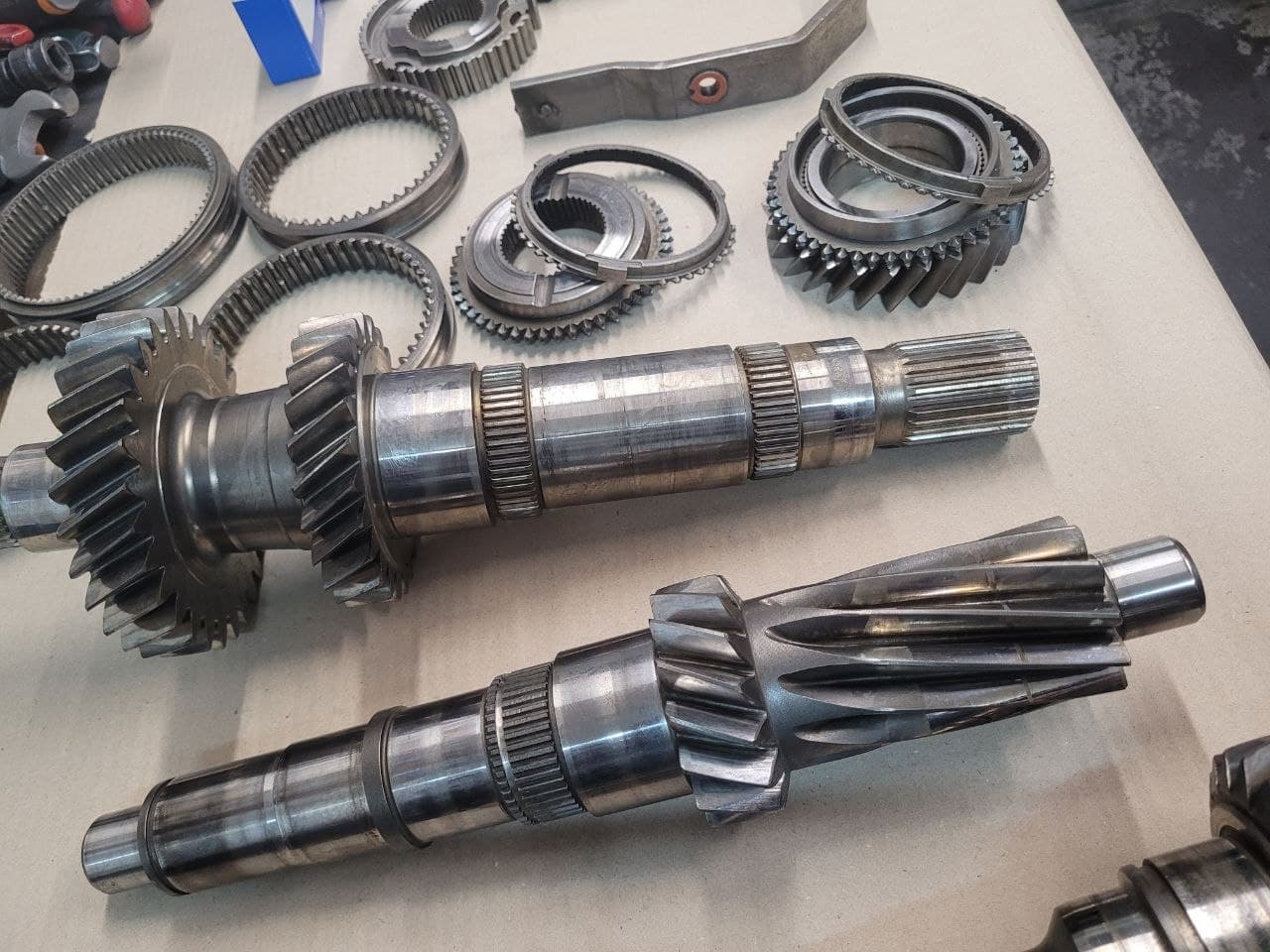 Gearbox shafts and gears laid out on a workbench